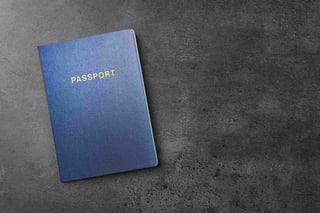 Blue passport on dark background