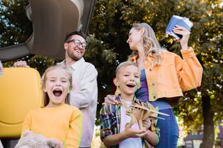 Kids standing near parents holding passports