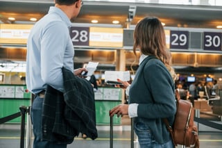 Looking At The Employee Young Couple Is In The Airport Together