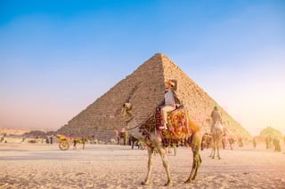 Mexican tourist riding a camel in Cairo Egypt