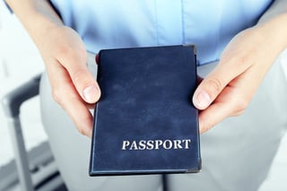Person holding a blue passport