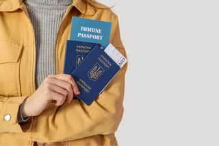 Woman With Ukrainian And Immune Passports On Light Background Closeup
