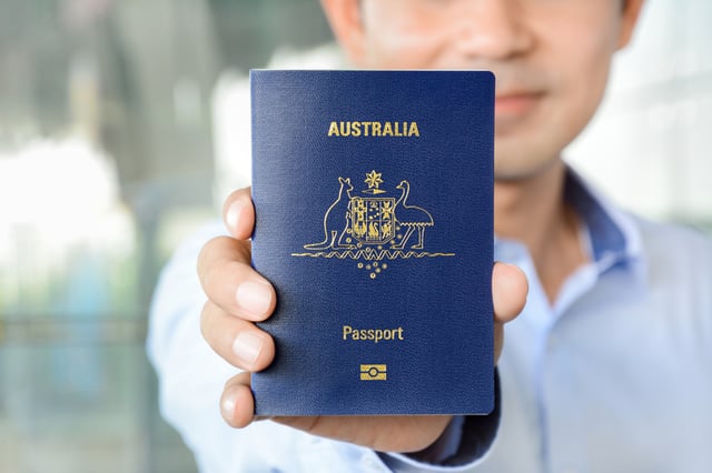 A Man Showing Passport Of Australia