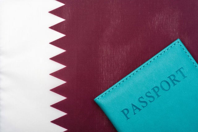 On The Background Of The Flag Of Qatar Is A Passport