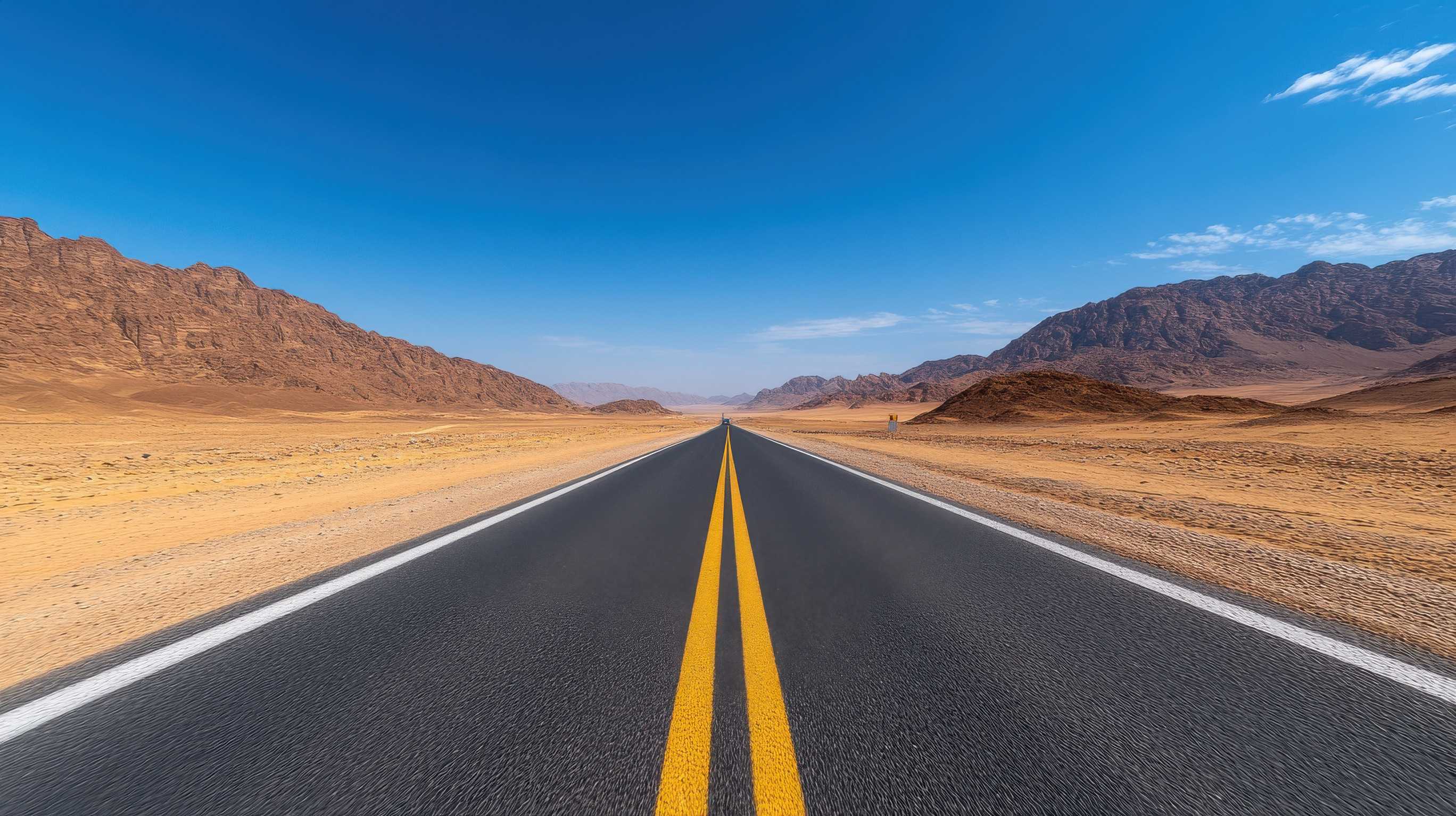 A Long Road With A Clear Blue Sky Above It