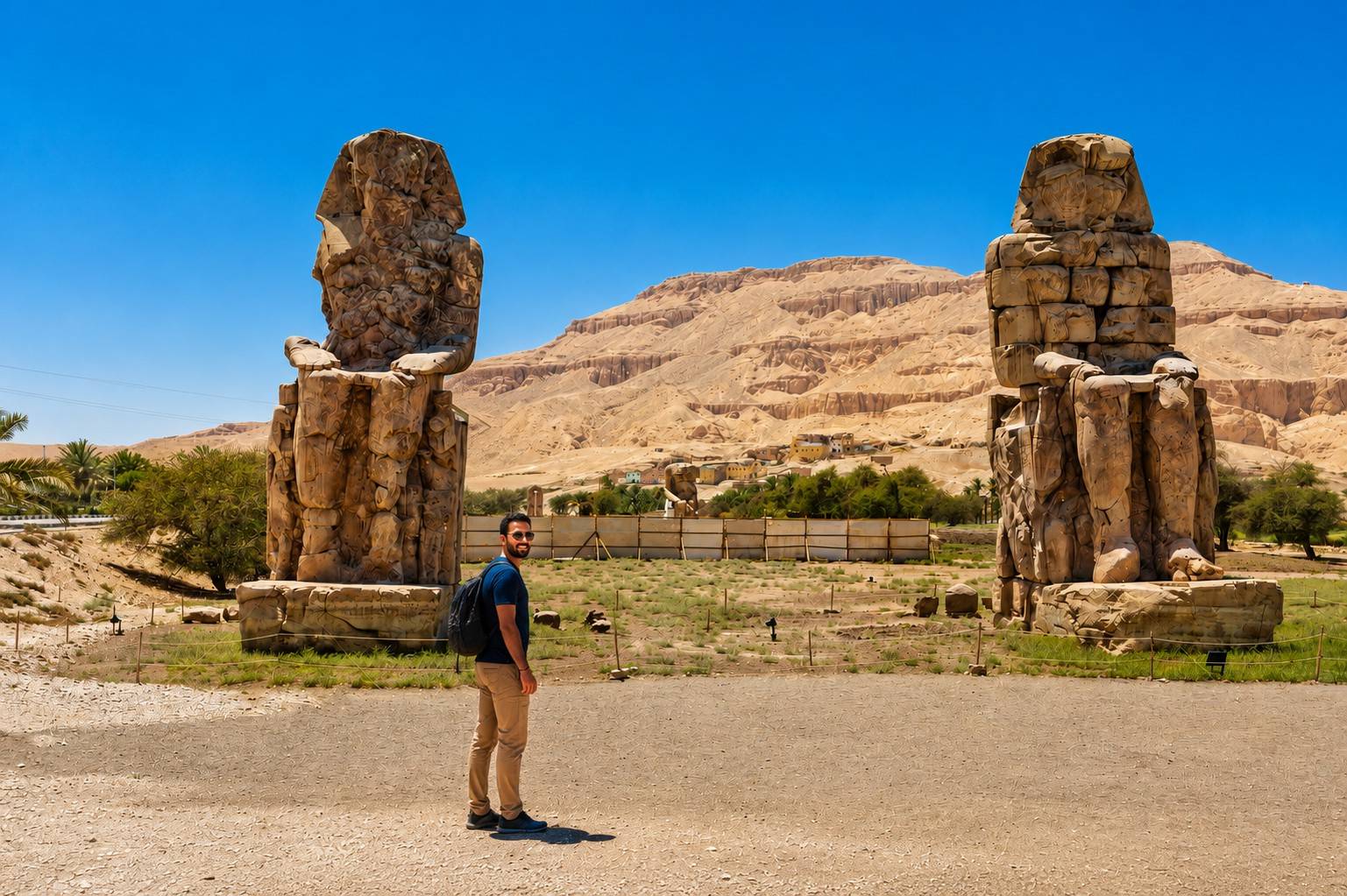 Tourist Visiting The Colossi Of Memnon Egypt